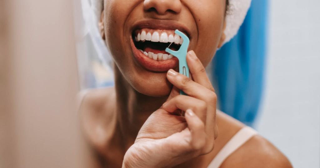 woman flosses with braces