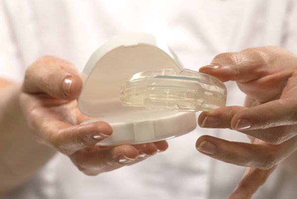 Orthodontist hands holding a box with Invisalign aligners