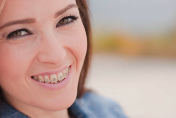 adult wearing braces uses mouthwash