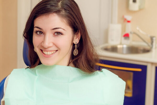 Young woman wondering if she'd need a dentist referral to begin her orthodontic journey