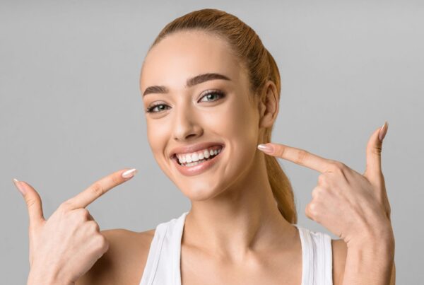 adult points to new smile after using payment plan for braces