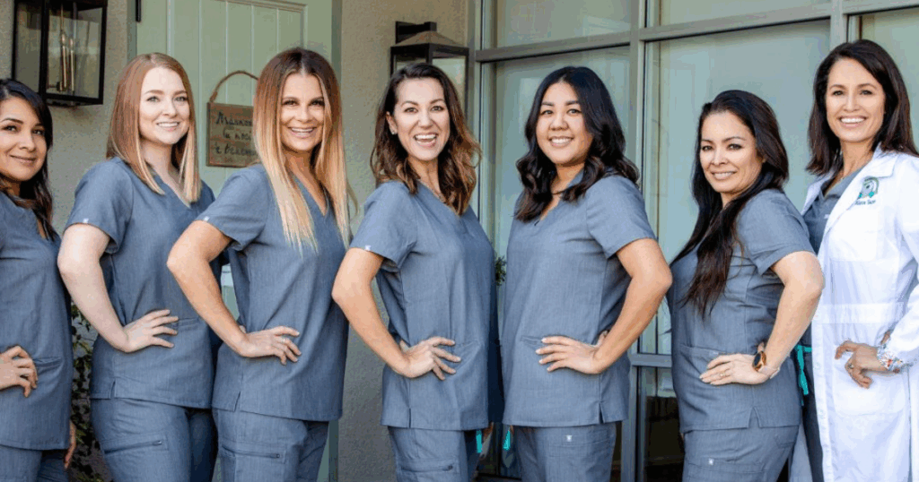 Saxe Orthodontics team members lined up, smiling, personalized orthodontics - braces and clear aligners in Summerlin, Las Vegas, NV
