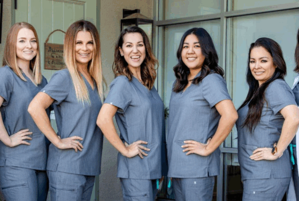 Saxe Orthodontics team members lined up, smiling, personalized orthodontics - braces and clear aligners in Summerlin, Las Vegas, NV